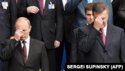 Володимир Путін і Віктор Янукович хрестяться під час богослужіння в Києві, 2013 р.