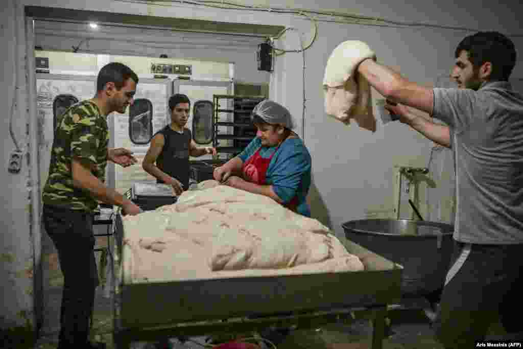 Workers at a bakery in Stepanakert prepare bread on October 21. The ethnic Armenian owners of the business are handing out their signature 700-gram loaves of bread for free to those who’ve remained in the city. 