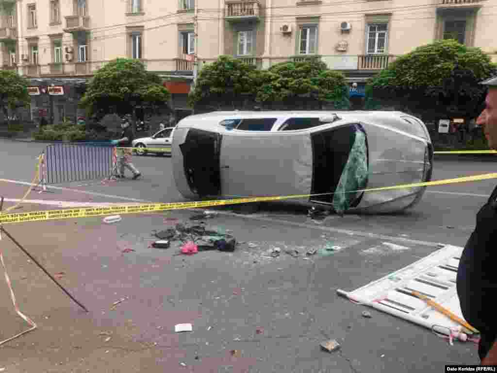 An overturned car as day breaks in Tbilisi on June 21. Opposition politician Grigol Vashadze vowed&nbsp;&ldquo;We will meet again on Rustaveli Avenue at 19:00 [on June 21].&nbsp;We will need to agree on an action plan with people.&quot;