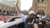 Hafiz Saeed waves to supporters as he leaves a court in Lahore in this 2017 photo.