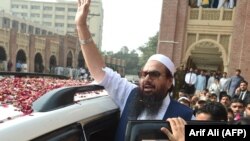 Hafiz Saeed waves to supporters as he leaves a court in Lahore in this 2017 photo.