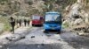 Pakistani security personnel inspect the site of a suicide attack in Khyber Pakhtunkhwa Province on March 26 that killed five Chinese engineers and a Pakistani driver.