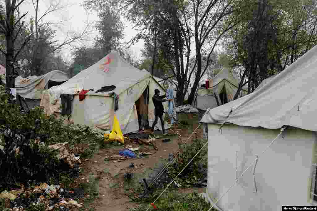 A migrant cleans his bedding among tents at the Vucjak camp. Since 2018, the EU has paid Bosnia 34 million euros ($37.4 million) to help manage the country’s migrant situation. 