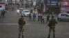 Indian paramilitary soldiers stand guard during curfew-like restrictions in Jammu on August 5.