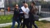  Жительницу города Семей Кенжегайшу Рахимбаеву (в центре) задерживают у здания генеральной прокуратуры при попытке провести акцию протеста. Астана, 16 сентября 2015 года.