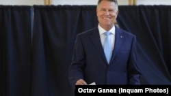 Romanian President Klaus Iohannis casts his vote in a May 26 referendum on changes to the country's judiciary and anti-corruption legislation. 