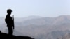 A soldier stands guard along the border fence outside the Kitton outpost on the border with Afghanistan in North Waziristan, Pakistan.