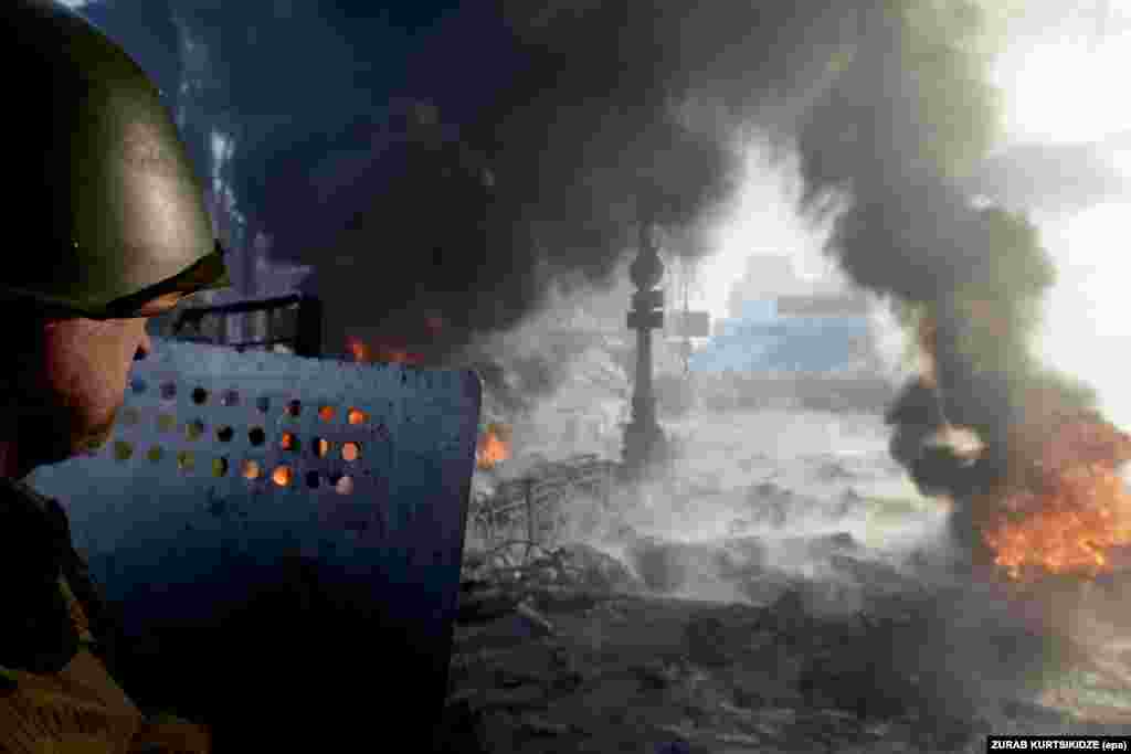 A protester stands on a barricade in downtown Kyiv.