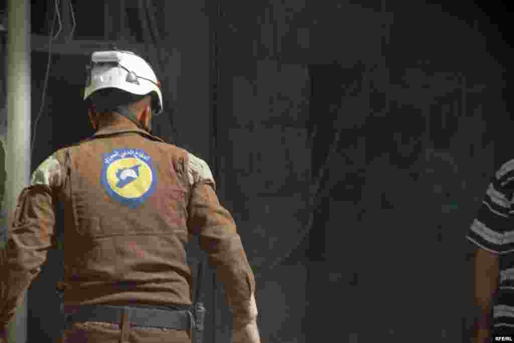 A rescue worker hunts for victims in a bombed-out building in Aleppo's Bustan al-Qasr district on October 11. The Syrian Observatory for Human Rights said at least 290 people, mostly civilians, have been killed by government or Russian air strikes since the operation to retake Aleppo began on September 22.
