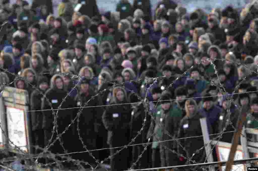 Inmates of a prison camp for women are seen through the razor wire before a "Lady Spring 2009" beauty contest in Selo Gornoye.