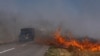 Cars drive along a burning field near Pokrovsk in Ukraine's eastern Donetsk region on September 16.