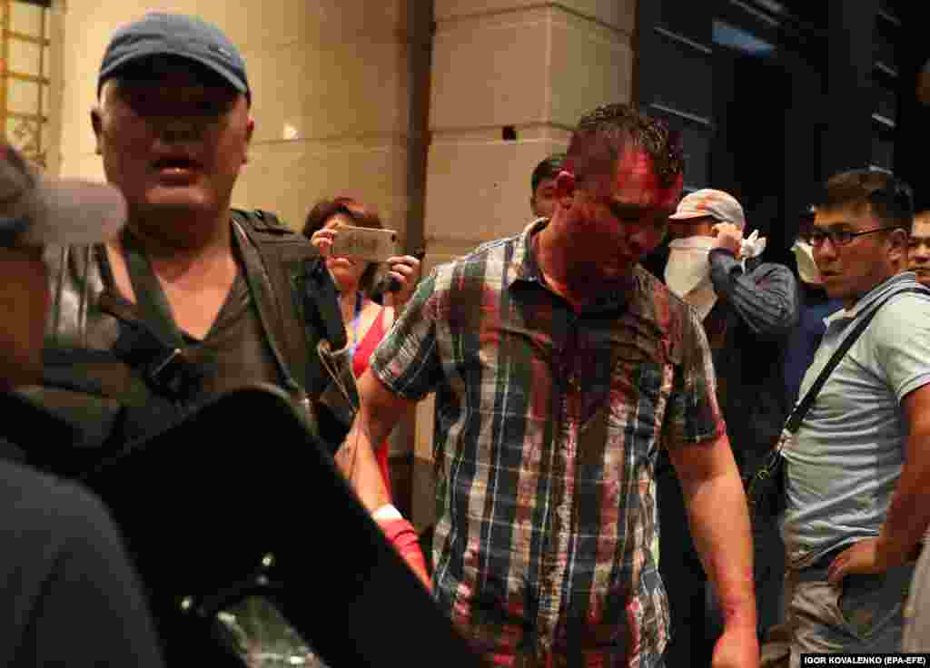 A blood-soaked man at the entrance to a building inside Atambaev’s residence.