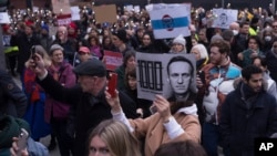 People attend a protest march to comemorate Russian opposition leader Aleksei Navalny near the Russian Embassy in Berlin on February 18.
