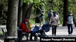 People enjoy walking in the Lazienki Royal Park after a loosening of the lockdown measures by the government due to the coronavirus disease in Warsaw on April 20.