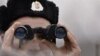 A Hungarian border guard peers toward Ukraine ahead of the Schengen expansion