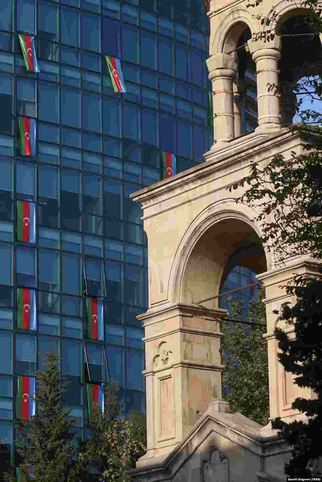 St. Gregory the Illuminator Church (right) and the offices of the International Bank of Azerbaijan are adorned with national flags on November 4. 