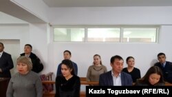 Three of the activists (back row, left to right) Anuar Ashiraliev, Oksana Shevchuk, and Gulzipa Zhaukerova in court on November 19.