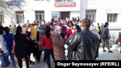 People gather outside a post office in Kyzylorda to collect social payments on April 6.