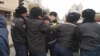 kazakh activist Dulat Aghadil (center) being detained by police in Nur-Sultan on October 26. 